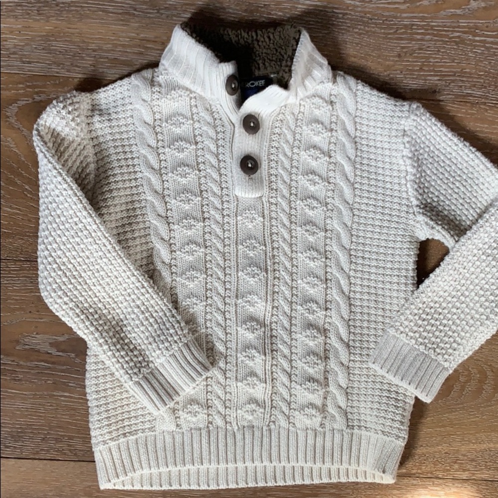 Cream cable knit sweater.